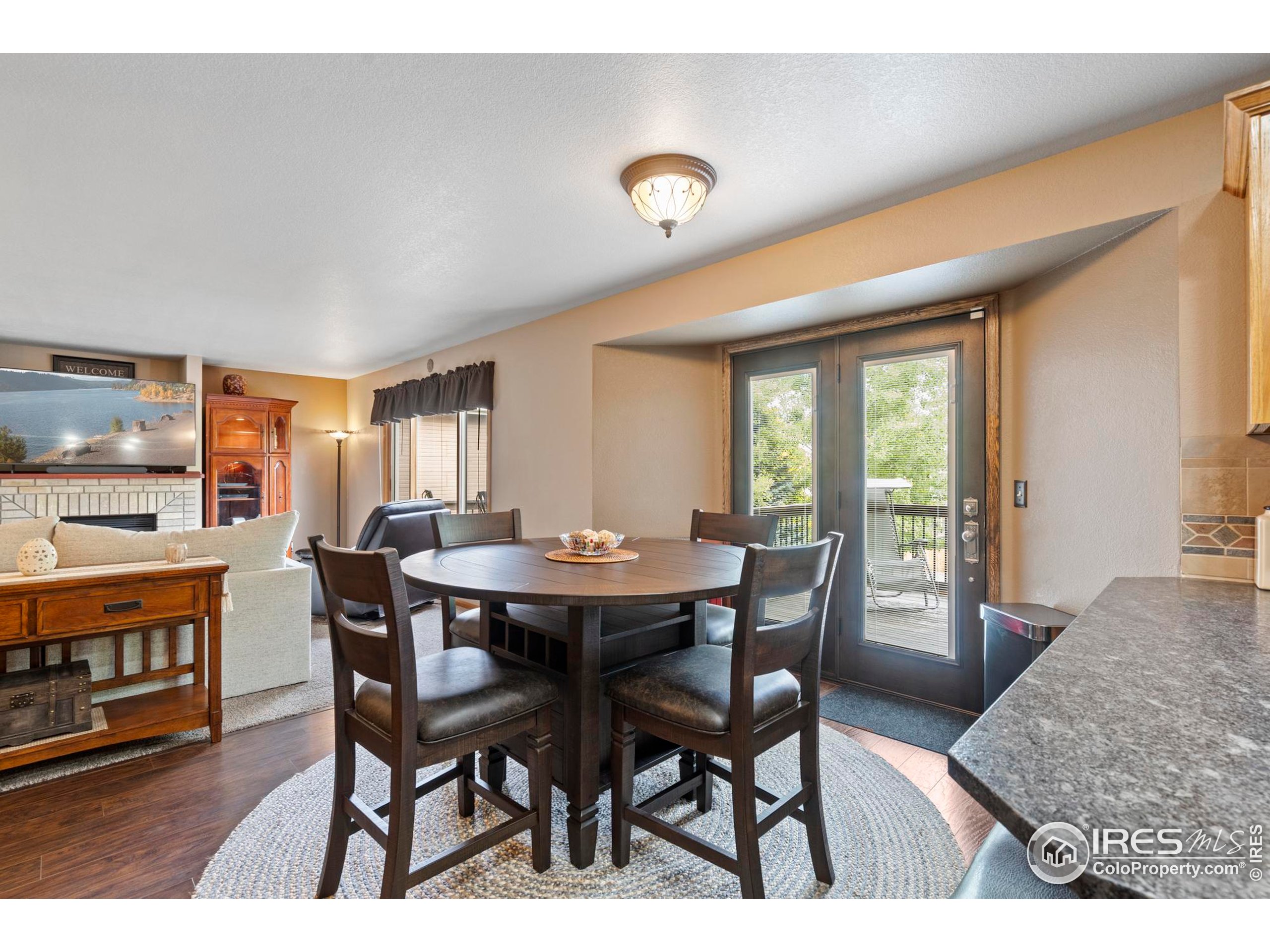 1808 Silvergate Road Fort Collins, CO 80526 - Photo 18 of 42 a view of a dining room with furniture and a window