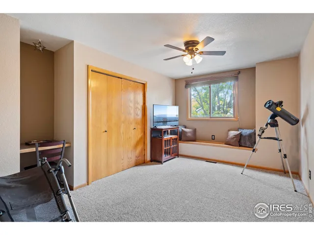 a bedroom with furniture and a window