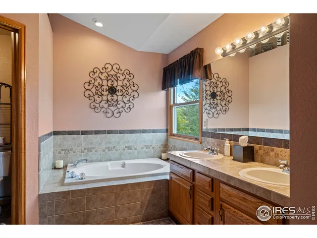 a bathroom with a bathtub sink and mirror