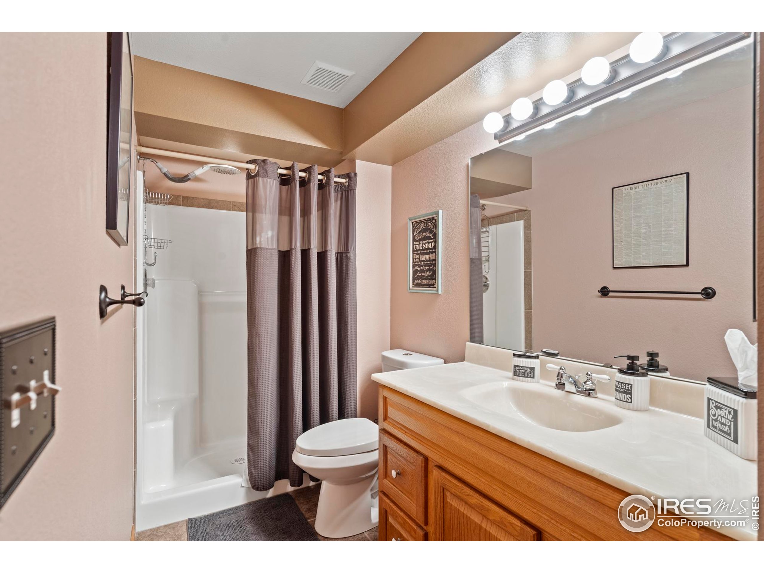 1808 Silvergate Road Fort Collins, CO 80526 - Photo 28 of 42 a bathroom with a sink a toilet a mirror and shower