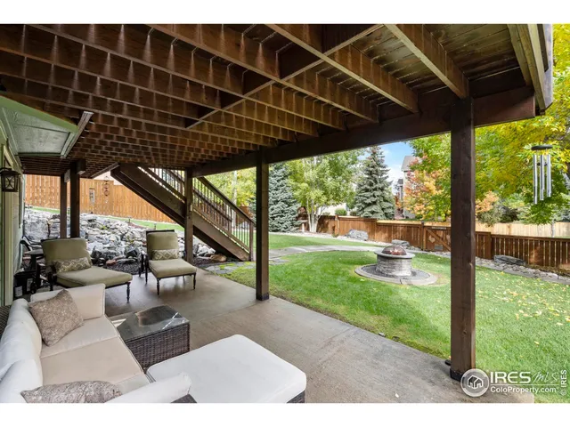 a view of a porch with furniture and garden