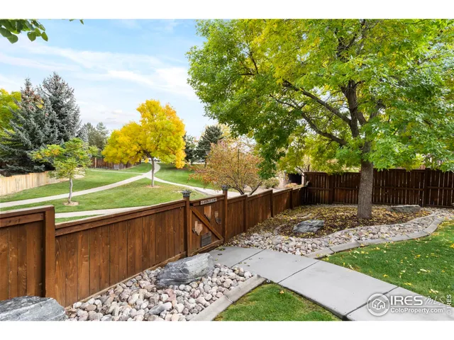 a view of a backyard with wooden fence
