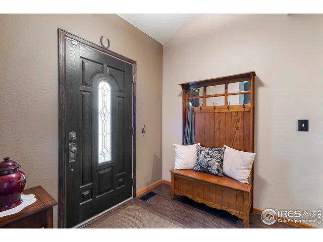 a living room with furniture and a mirror