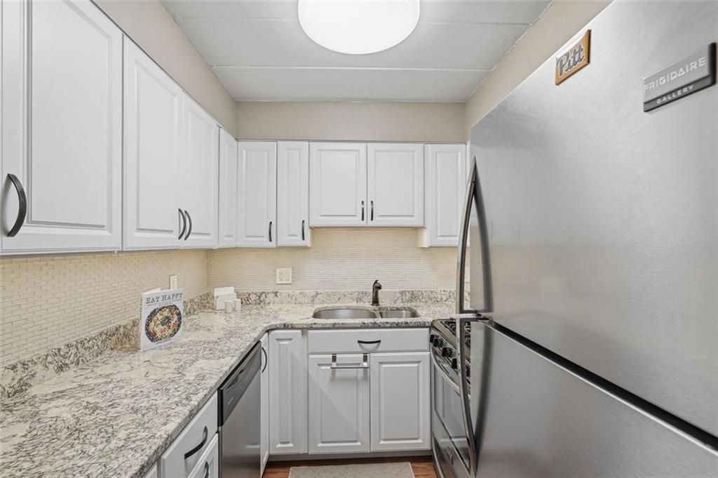 5 Bayard Road, Unit 520 Pittsburgh, PA 15213 - Photo 12 of 25 a kitchen with a sink a stove and cabinets