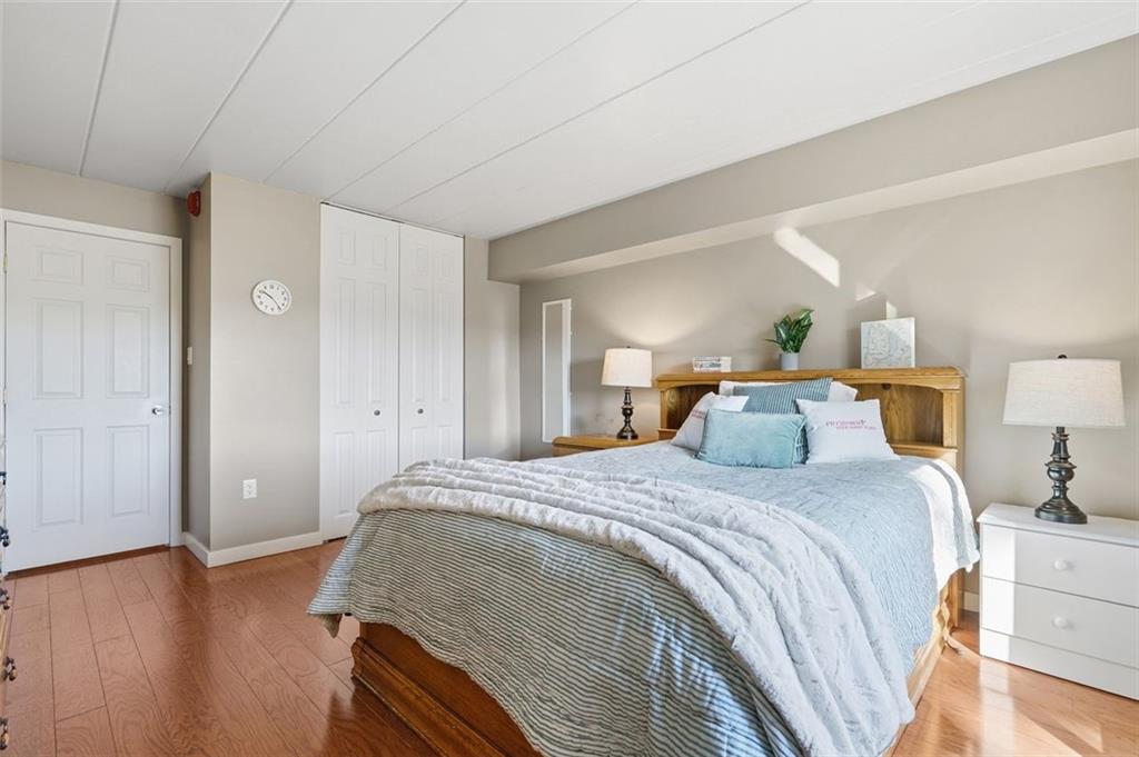 5 Bayard Road, Unit 520 Pittsburgh, PA 15213 - Photo 15 of 25 a bedroom with a bed and wooden floor