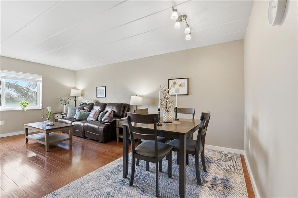 5 Bayard Road, Unit 520 Pittsburgh, PA 15213 - Photo 5 of 25 a dining room with wooden floor a chandelier fan a wooden table and chairs