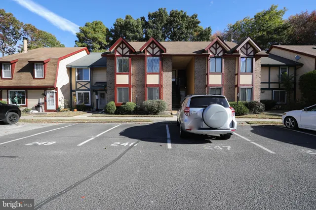 a front view of a residential apartment building with a yard
