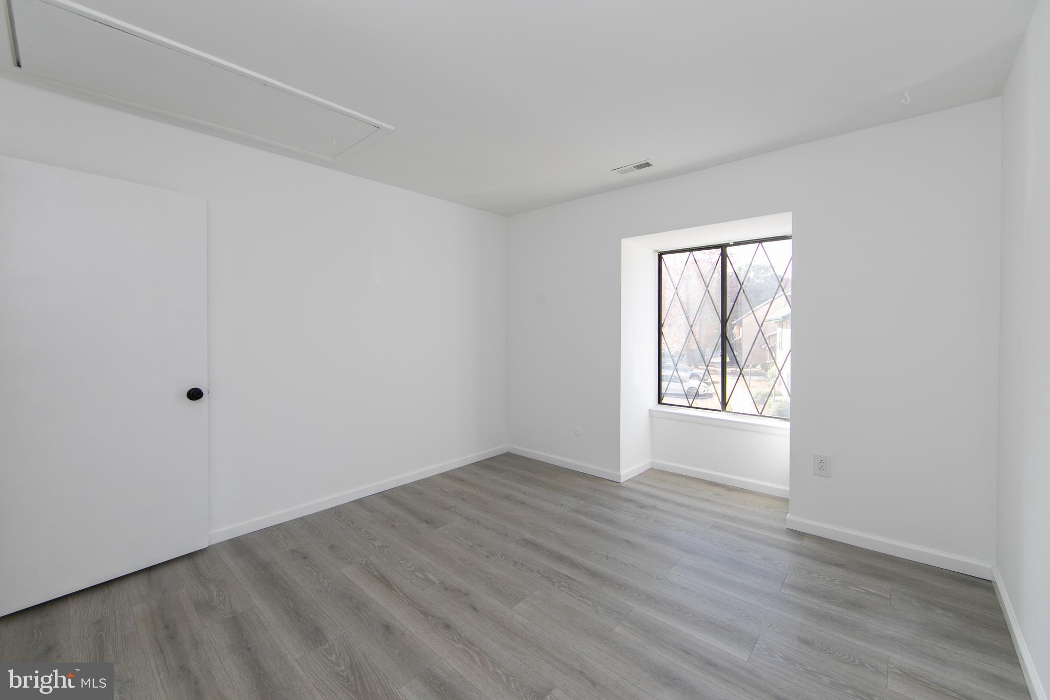 108 Chelsea Circle Clementon, NJ 08021 - Photo 12 of 19 an empty room with wooden floor and windows