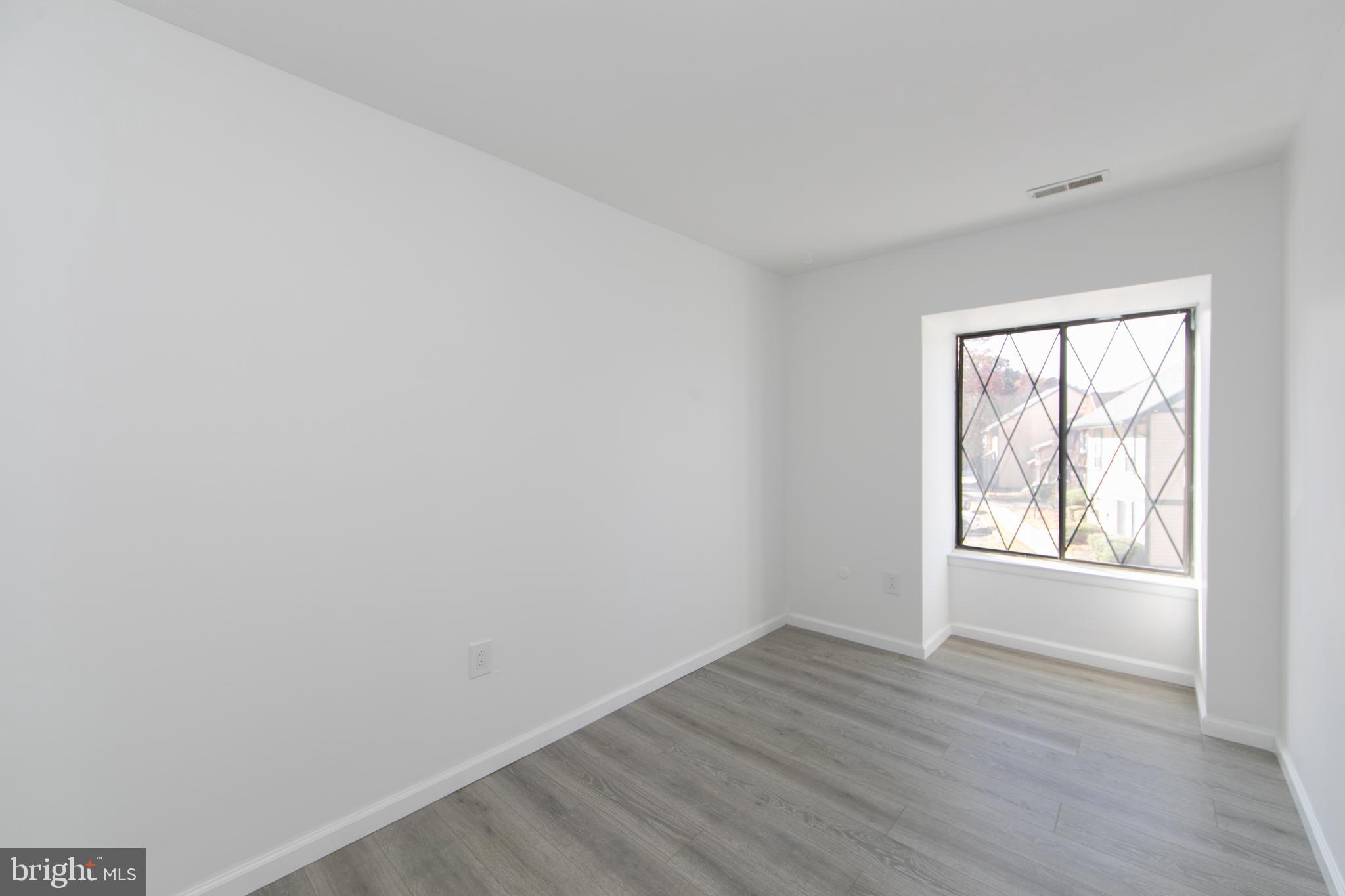 108 Chelsea Circle Clementon, NJ 08021 - Photo 13 of 19 an empty room with wooden floor and windows