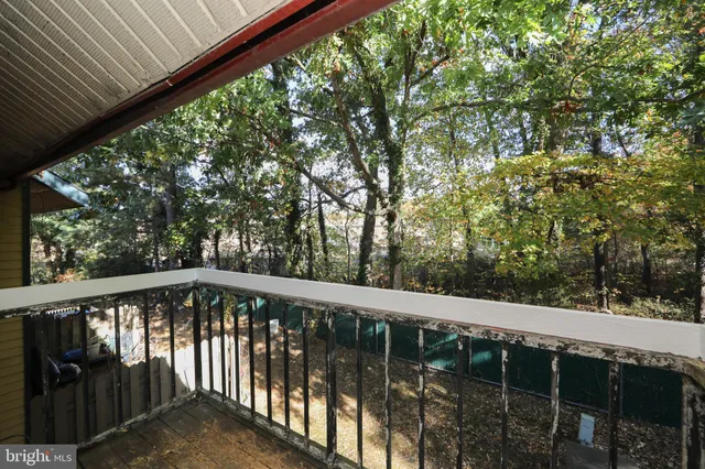 a view of a balcony with yard