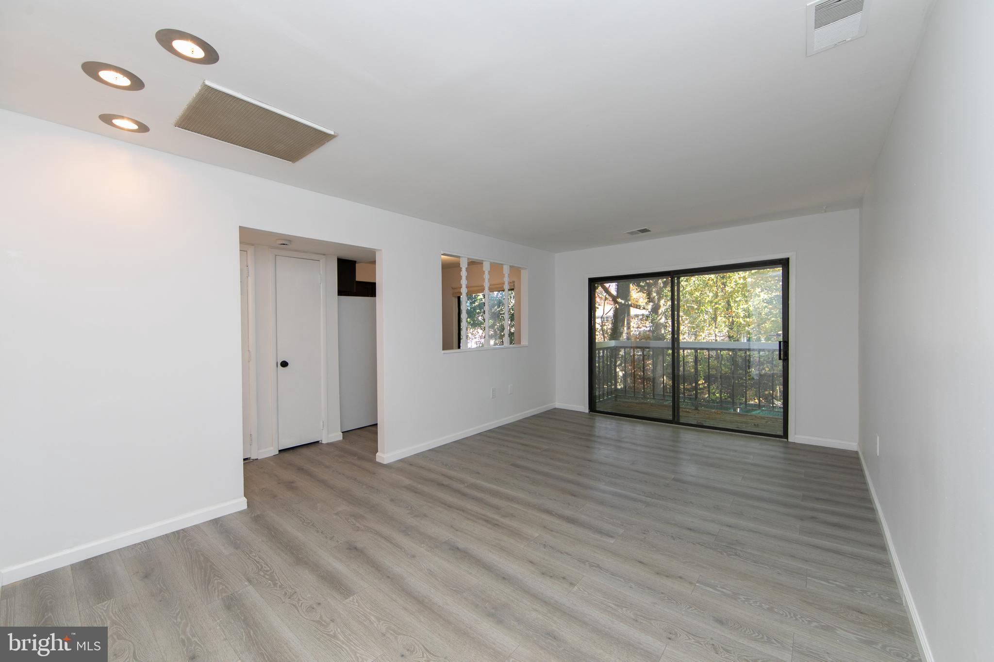 108 Chelsea Circle Clementon, NJ 08021 - Photo 4 of 19 an empty room with wooden floor and windows