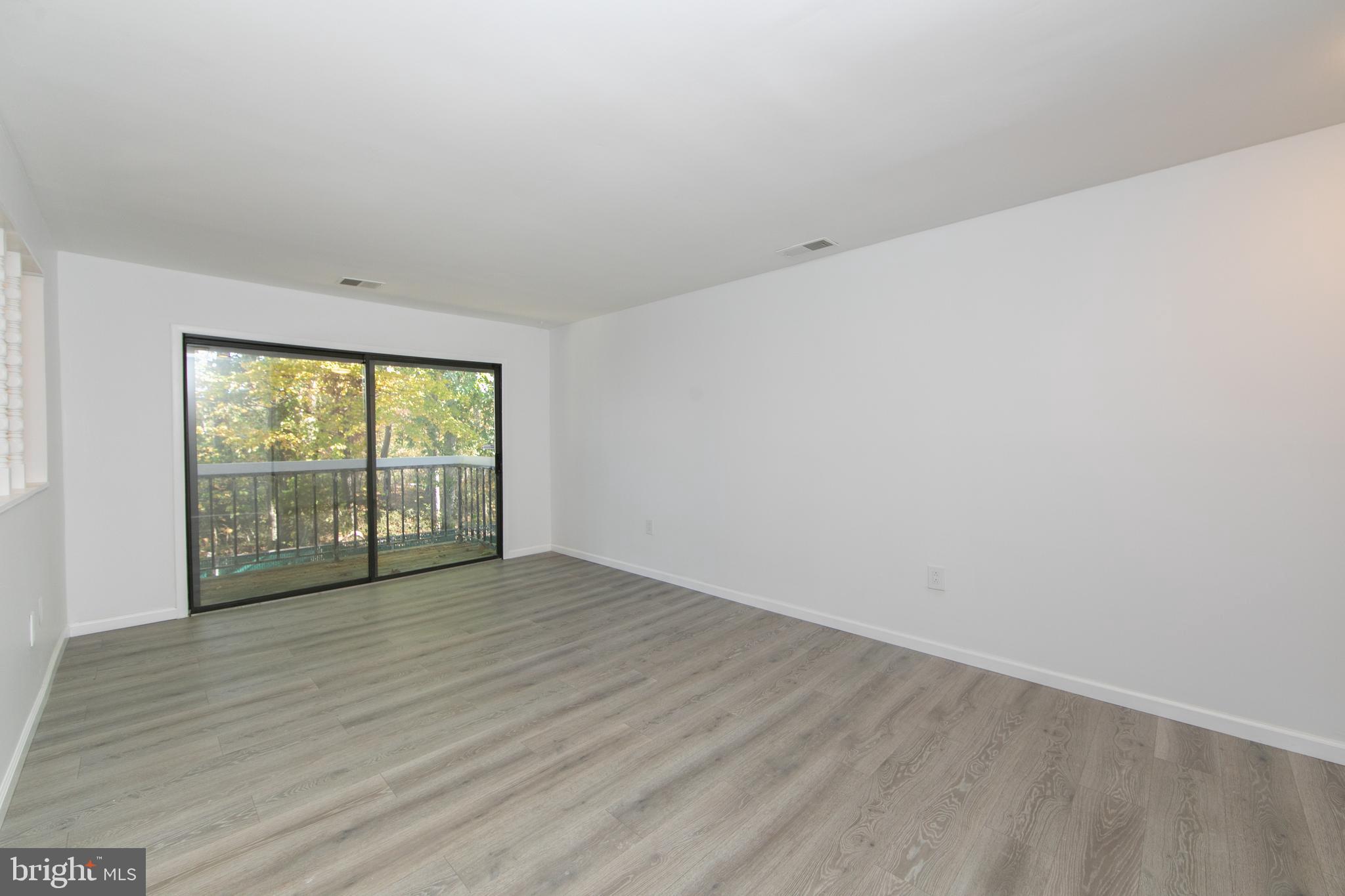 108 Chelsea Circle Clementon, NJ 08021 - Photo 5 of 19 a view of an empty room with wooden floor and a window