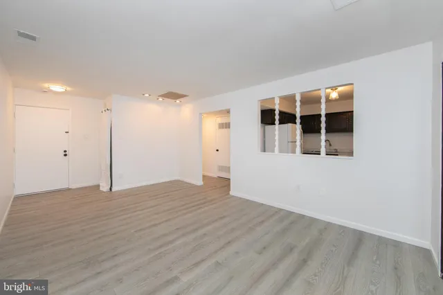 a big room with wooden floor and windows