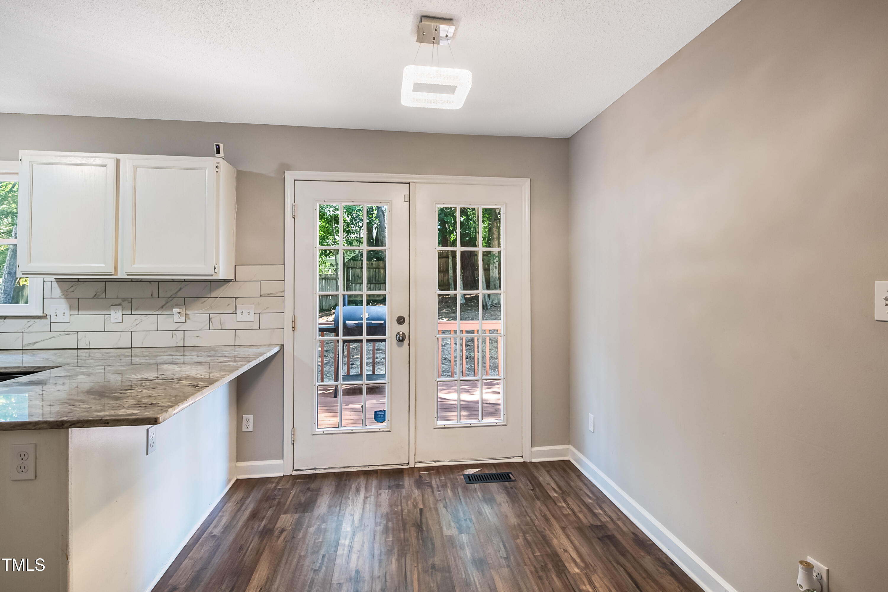 2704 Rockbridge Court Raleigh, NC 27604 - Photo 4 of 15 a kitchen with wooden floors and white cabinets