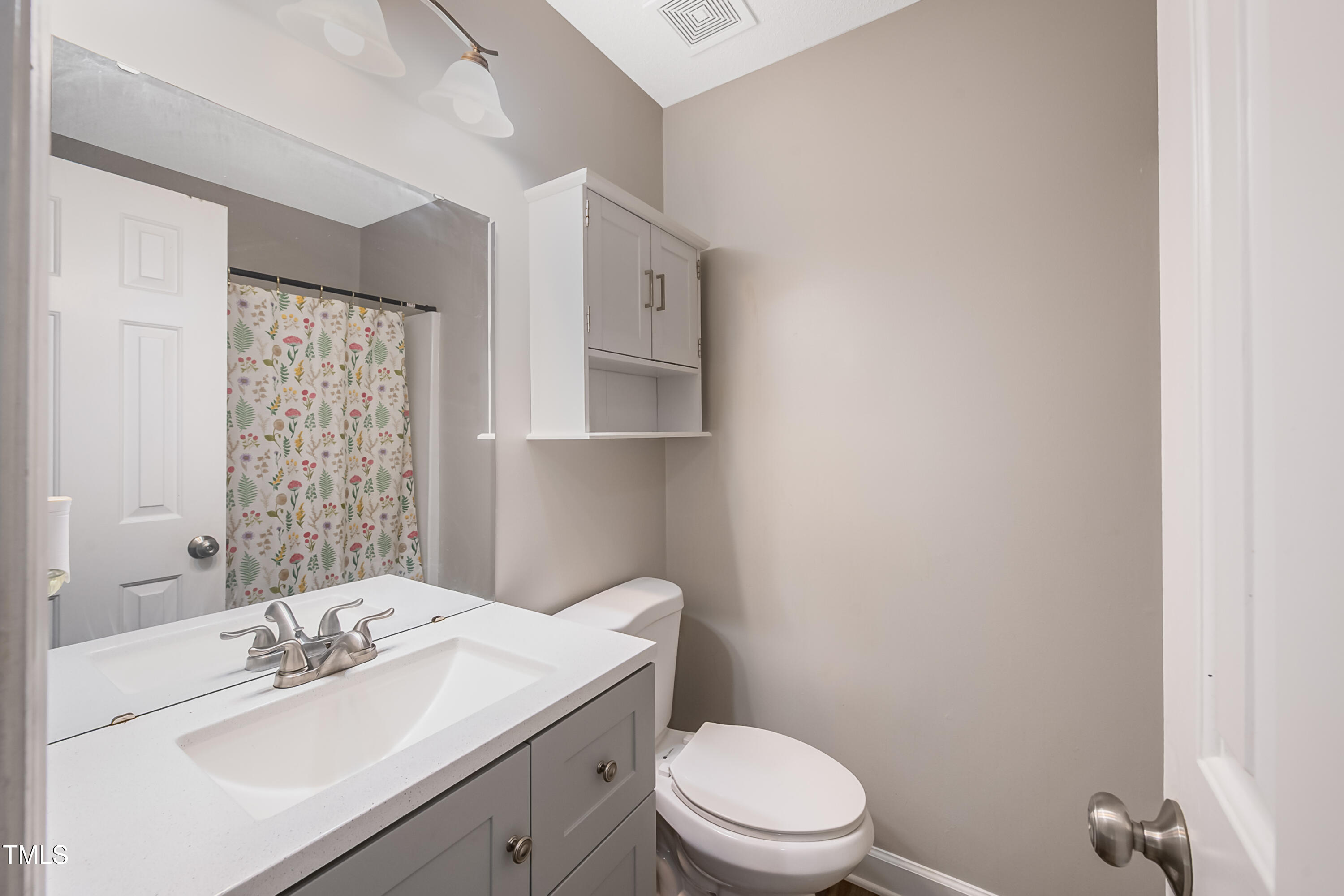 2704 Rockbridge Court Raleigh, NC 27604 - Photo 7 of 15 a bathroom with a sink a toilet and shower