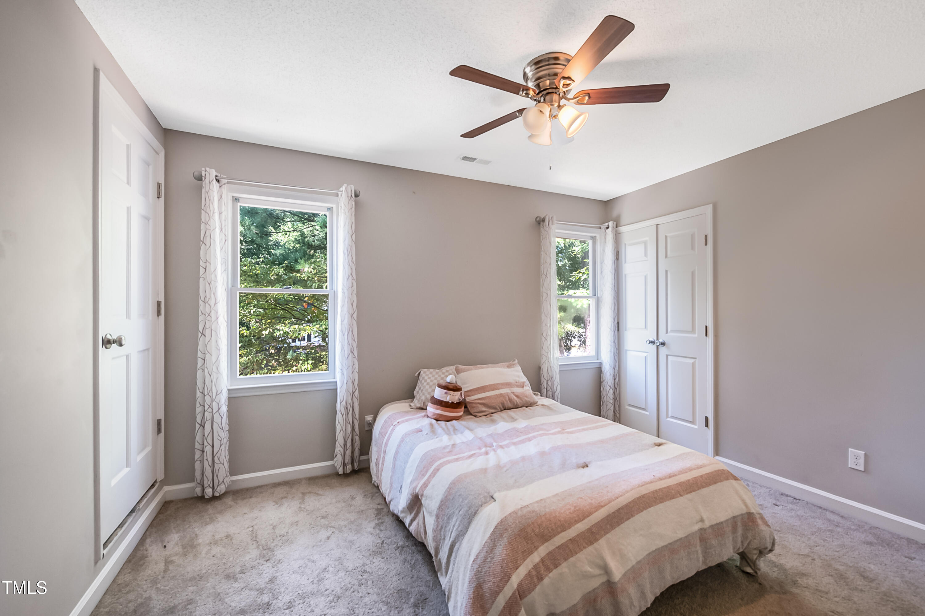 2704 Rockbridge Court Raleigh, NC 27604 - Photo 8 of 15 a bedroom with a bed and a ceiling fan