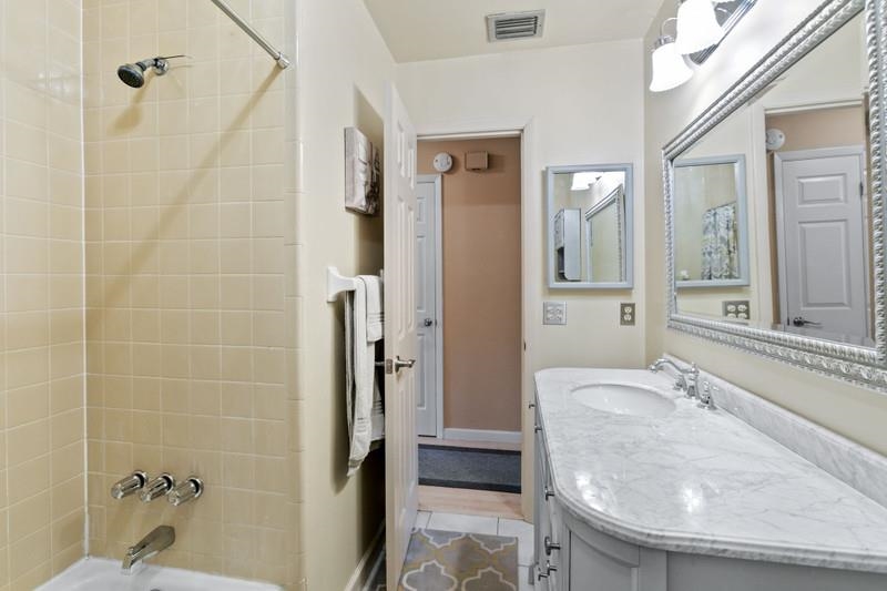 116 Loyola Road St. Augustine, FL 32086 - Photo 32 of 41 a bathroom with a granite countertop shower a mirror and a sink
