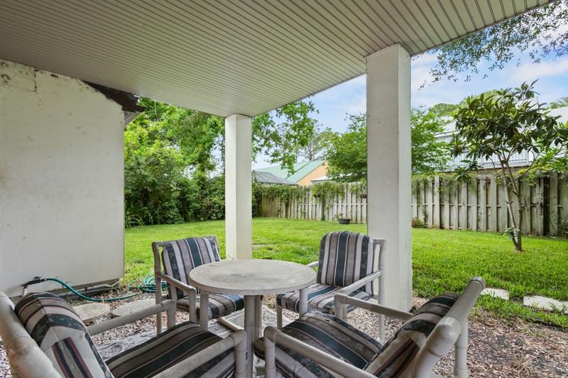 116 Loyola Road St. Augustine, FL 32086 - Photo 37 of 41 a view of a patio with a table chairs and a table