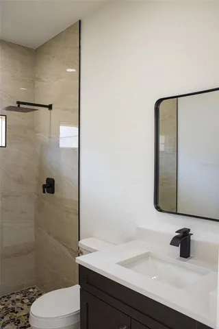 a bathroom with a sink toilet and shower