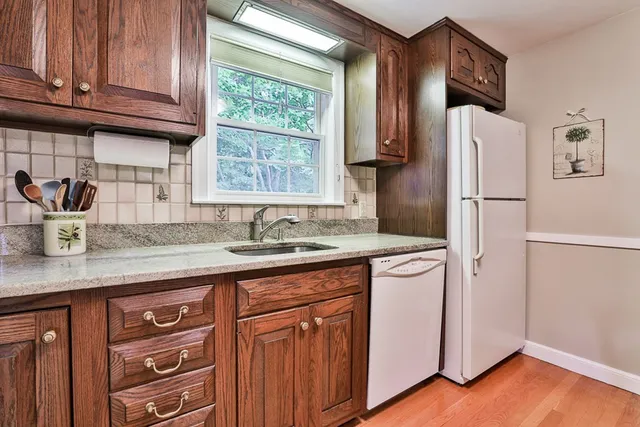 a kitchen with stainless steel appliances granite countertop a refrigerator sink and cabinets