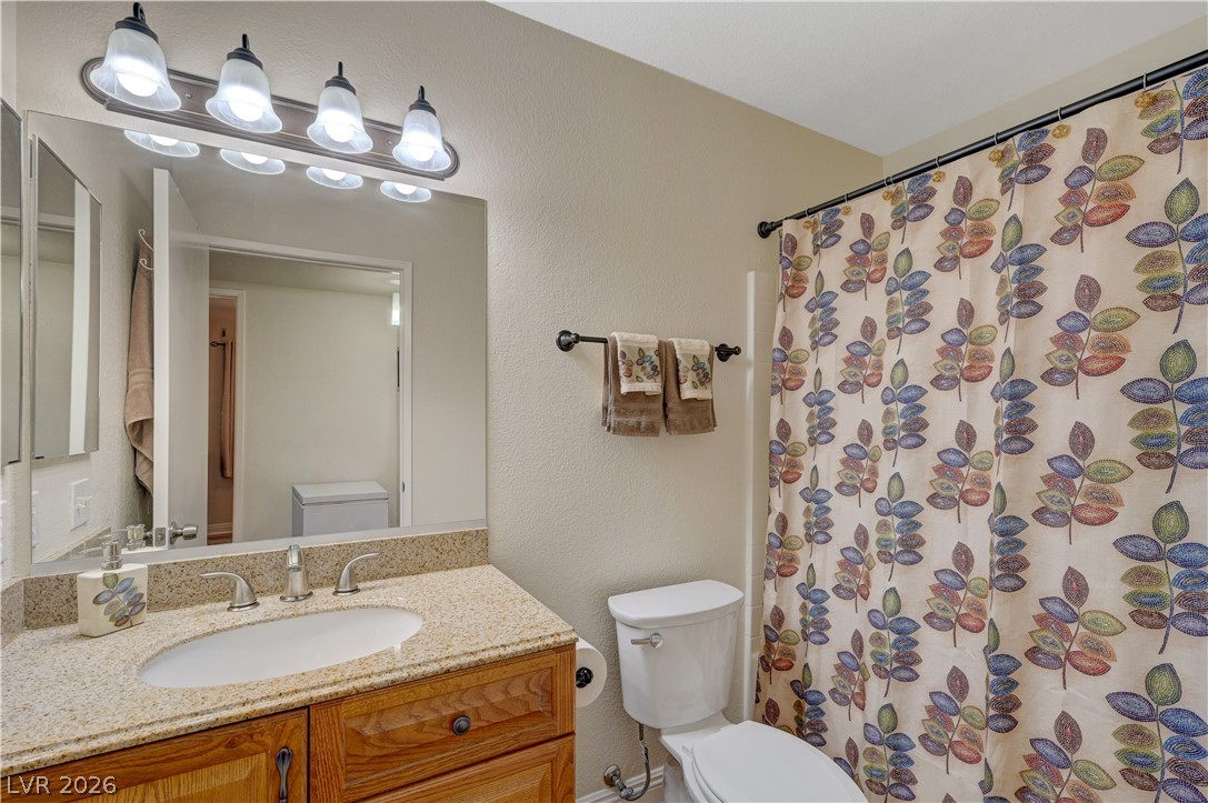 7885 West Flamingo Road, Unit 1071 Las Vegas, NV 89147 - Photo 19 of 28 Functional full bathroom with granite-topped vanity.