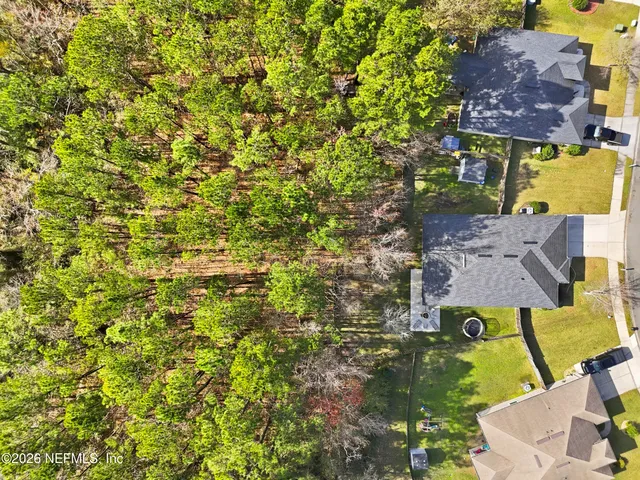 a aerial view of a swimming pool with a yard