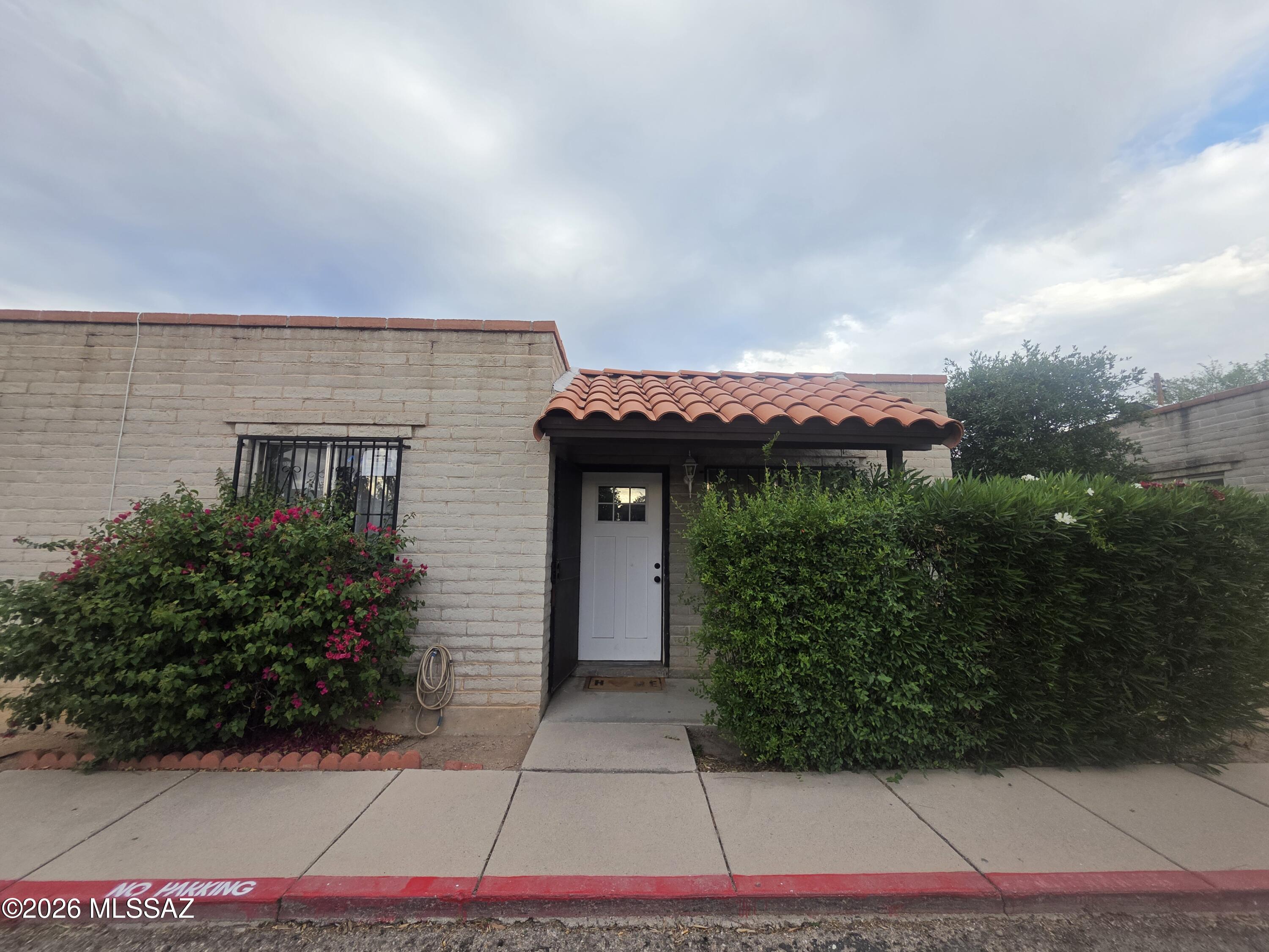 211 West Roger Road, Unit 24 Tucson, AZ 85705 - Photo 1 of 24 a front view of house with yard