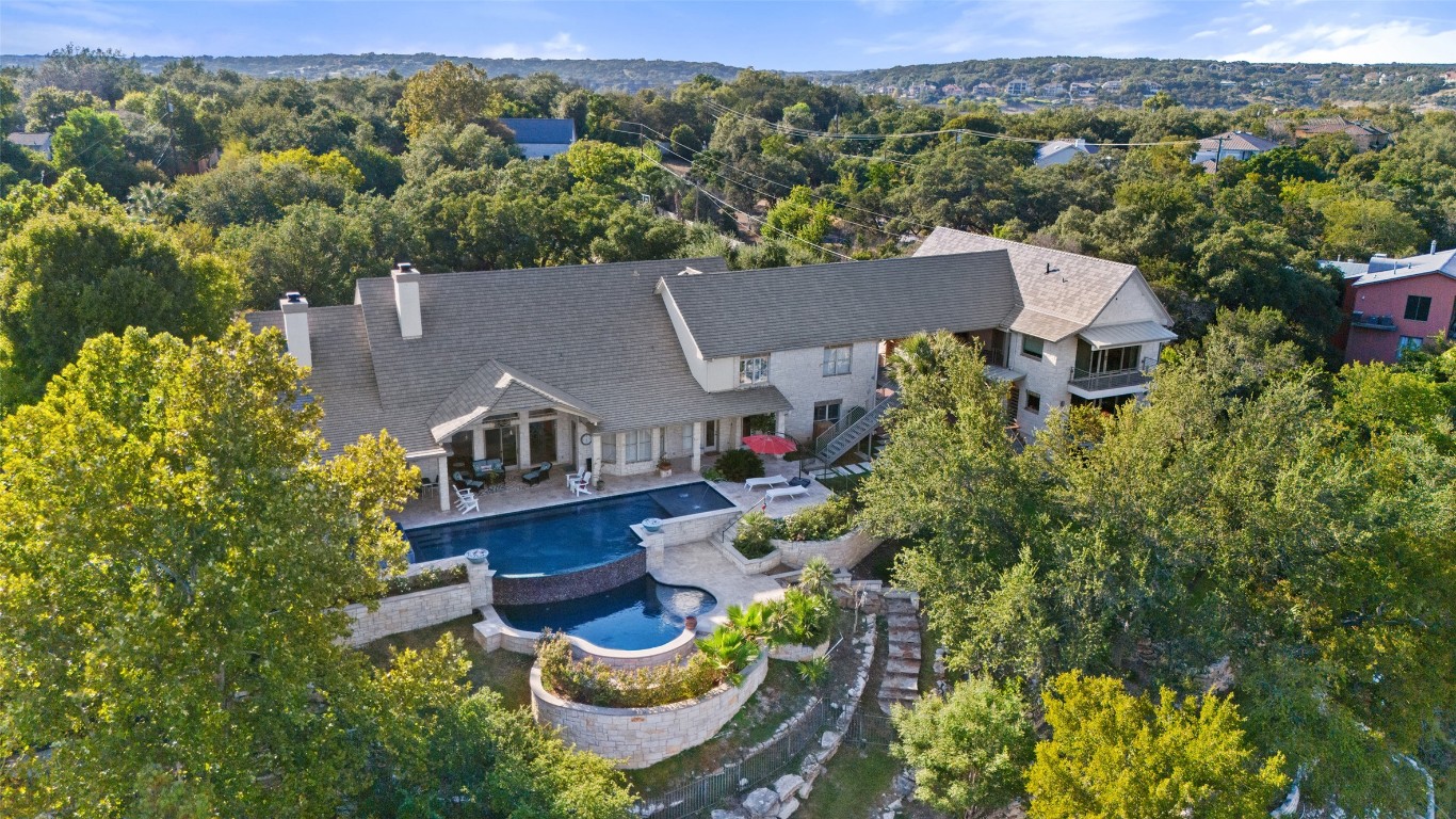 an aerial view of a house with a garden and lake view