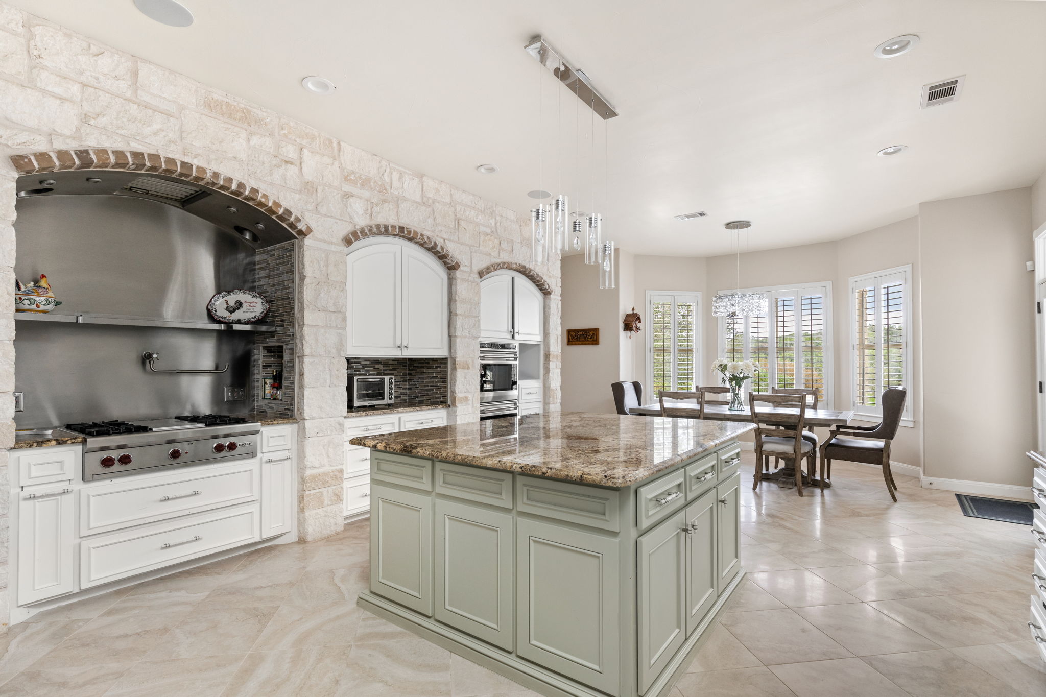 805 Brooks Hollow Road Lakeway, TX 78734 - Photo 11 of 38 a kitchen with granite countertop a sink stove and cabinets