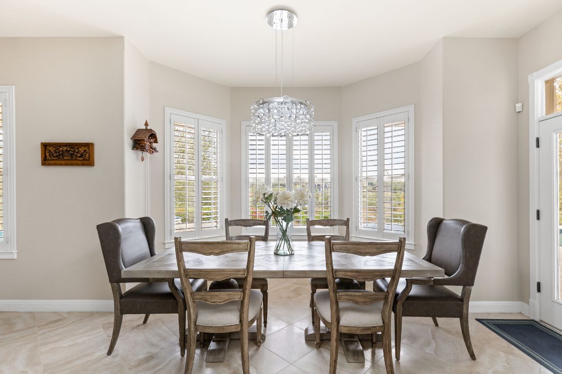 805 Brooks Hollow Road Lakeway, TX 78734 - Photo 12 of 38 a view of a dining room with furniture windows and wooden floor