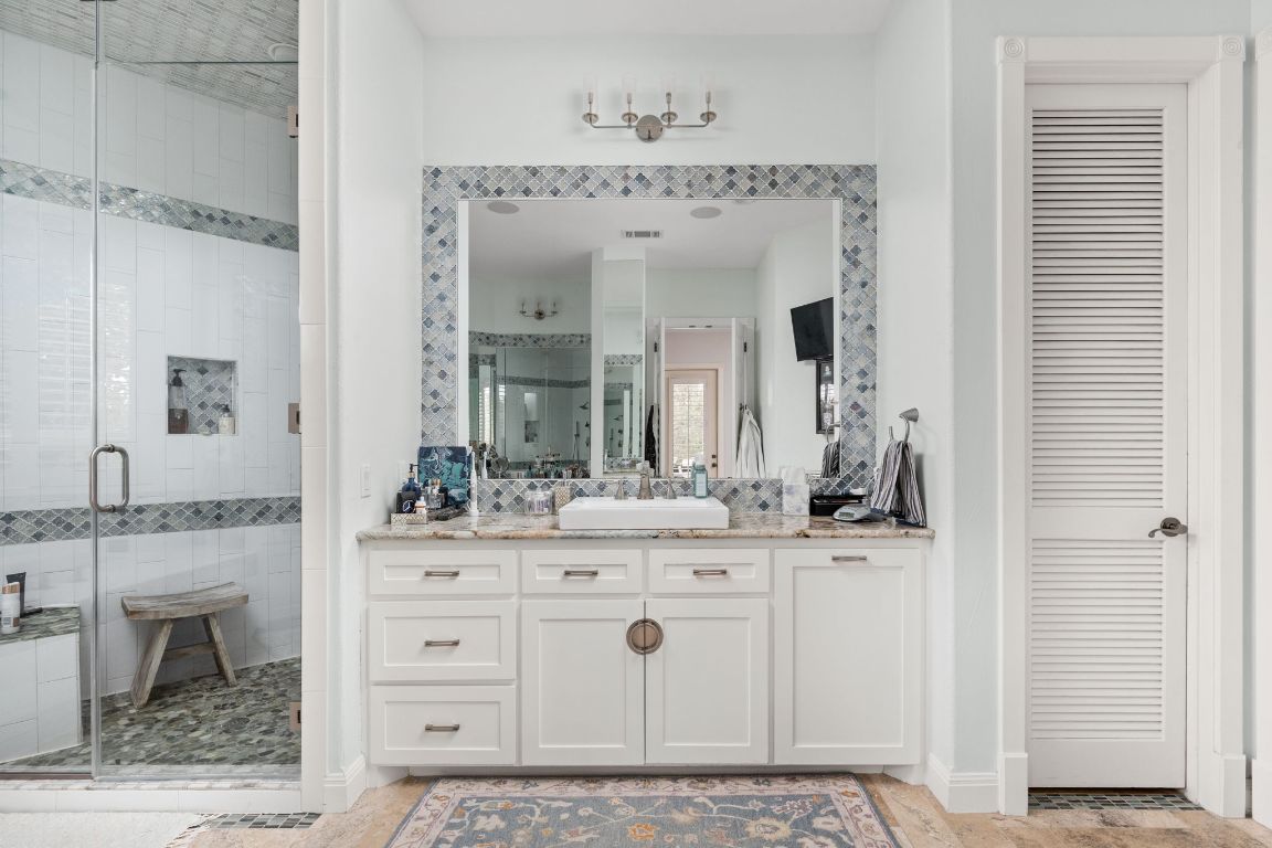 805 Brooks Hollow Road Lakeway, TX 78734 - Photo 13 of 38 a bathroom with a sink vanity and a mirror