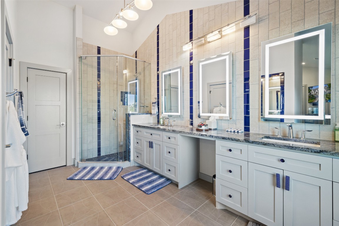 805 Brooks Hollow Road Lakeway, TX 78734 - Photo 14 of 38 a spacious bathroom with a double vanity sink mirror and double