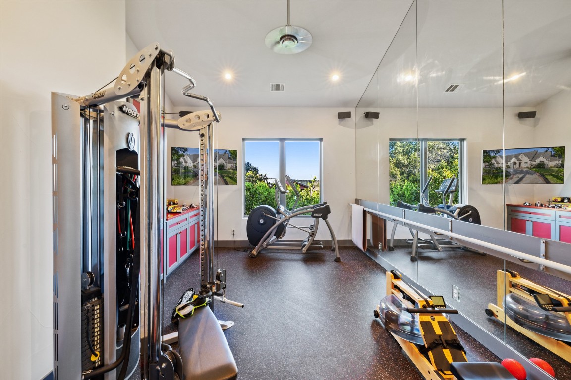 805 Brooks Hollow Road Lakeway, TX 78734 - Photo 16 of 38 a very nice looking room with a large window and gym equipment
