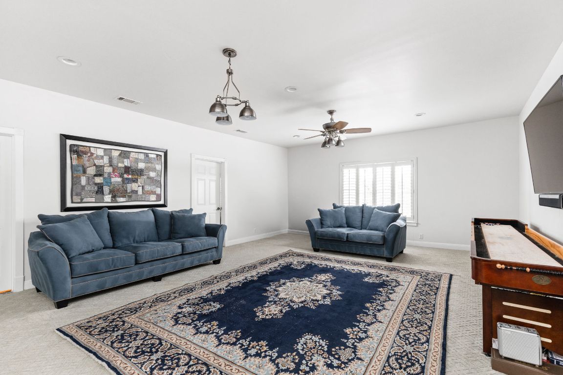 805 Brooks Hollow Road Lakeway, TX 78734 - Photo 21 of 38 a living room with furniture and a rug
