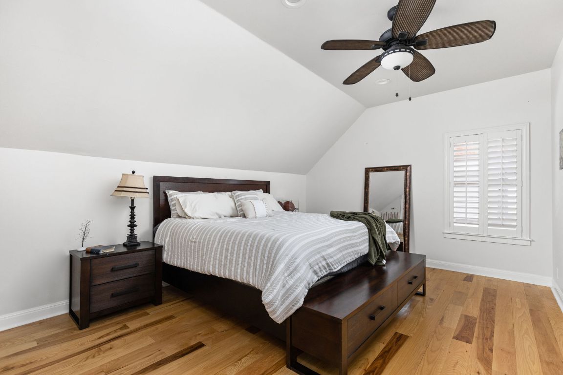 805 Brooks Hollow Road Lakeway, TX 78734 - Photo 22 of 38 a bedroom with a bed window and a ceiling fan