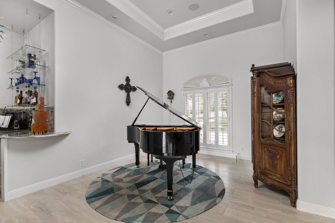 805 Brooks Hollow Road Lakeway, TX 78734 - Photo 34 of 38 a living room with furniture a dining table and a chandelier