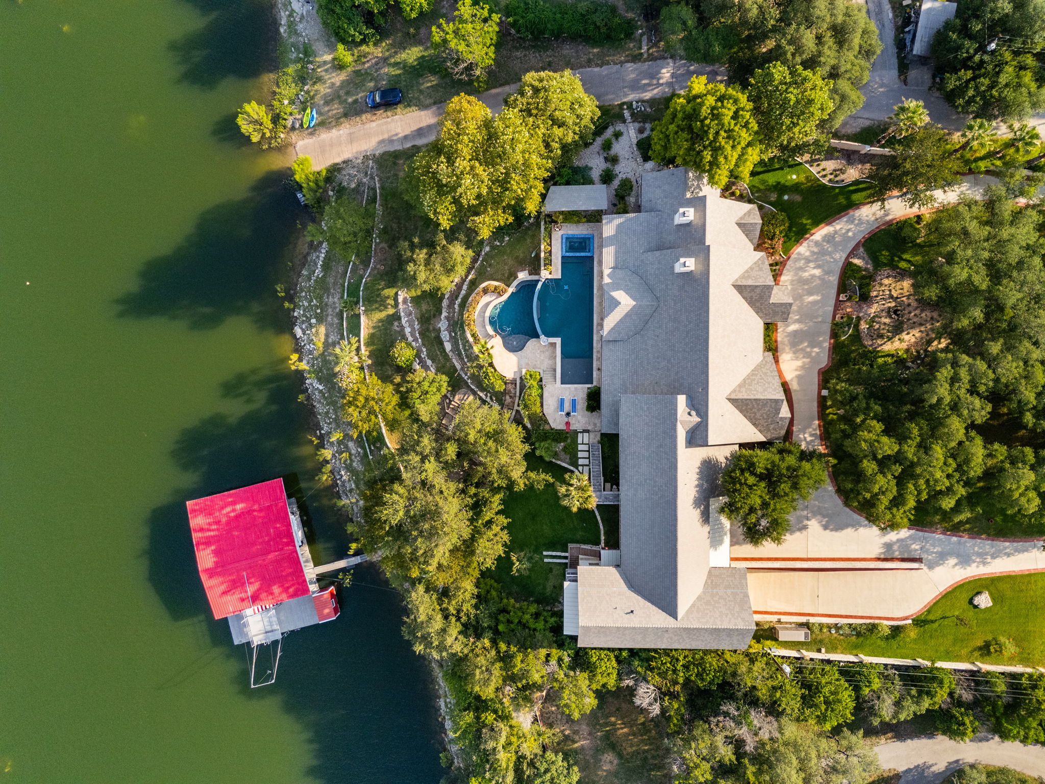 805 Brooks Hollow Road Lakeway, TX 78734 - Photo 36 of 38 an aerial view of a house with a garden and swimming pool