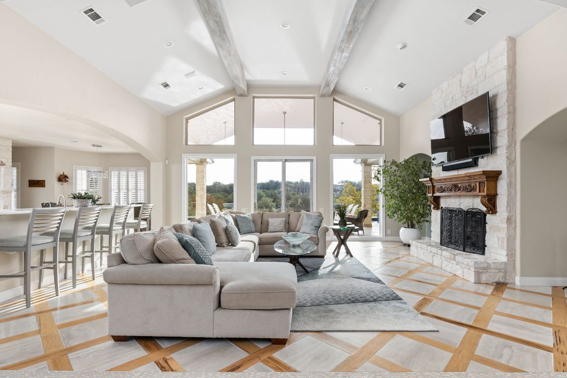 805 Brooks Hollow Road Lakeway, TX 78734 - Photo 4 of 38 a living room with fireplace furniture and a flat screen tv