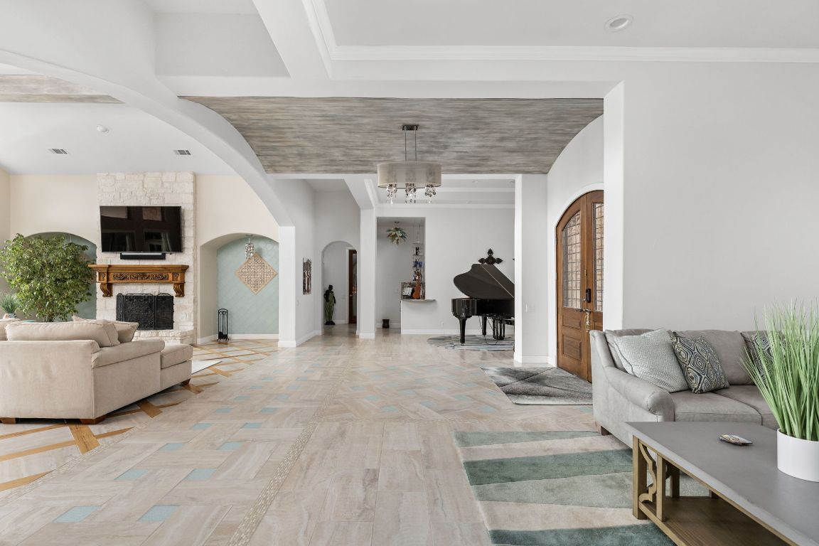 805 Brooks Hollow Road Lakeway, TX 78734 - Photo 5 of 38 a living room with furniture and a fireplace