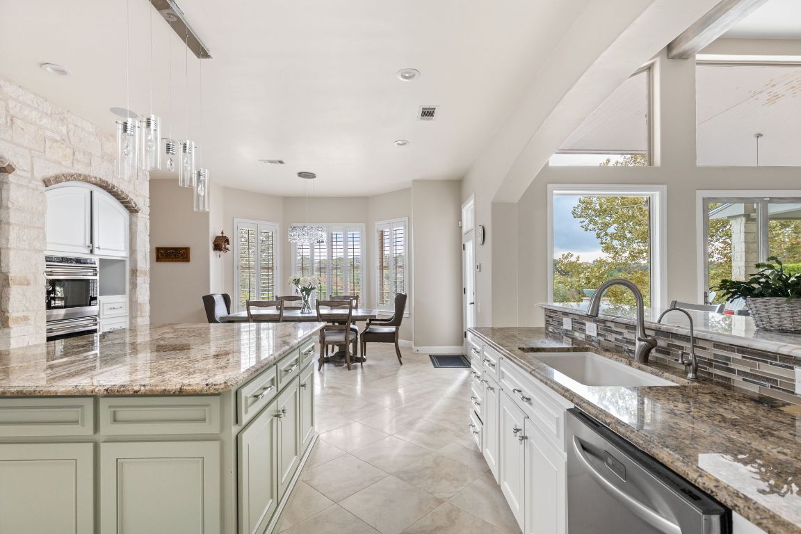 805 Brooks Hollow Road Lakeway, TX 78734 - Photo 10 of 38 a large kitchen with granite countertop a lot of counter space