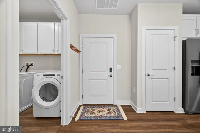 a large kitchen with stainless steel appliances granite countertop a sink a stove and a refrigerator