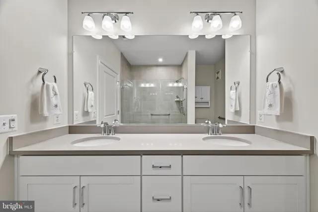 a view of a livingroom with wooden floor and a bathroom