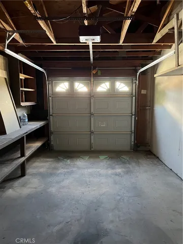a kitchen with wooden floors and cabinets