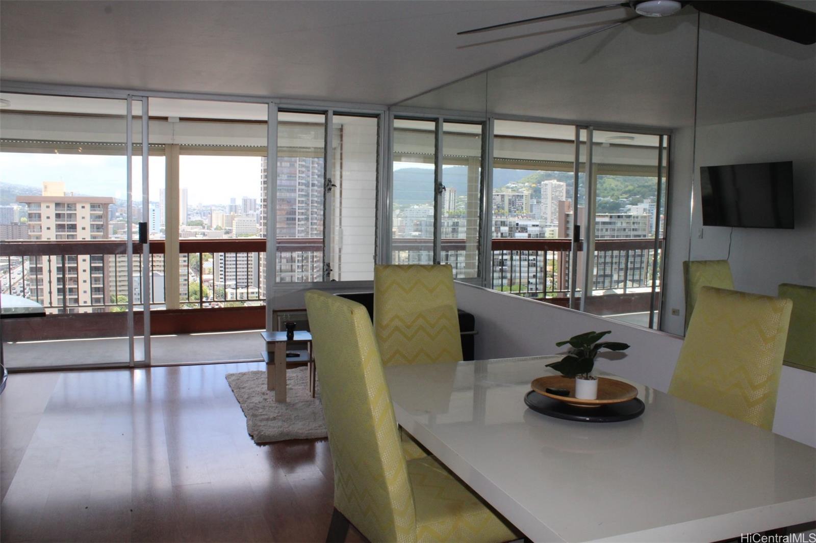 775 Kinalau Place, Unit 2107 Honolulu, HI 96813 - Photo 6 of 13 a living room with furniture and a large window