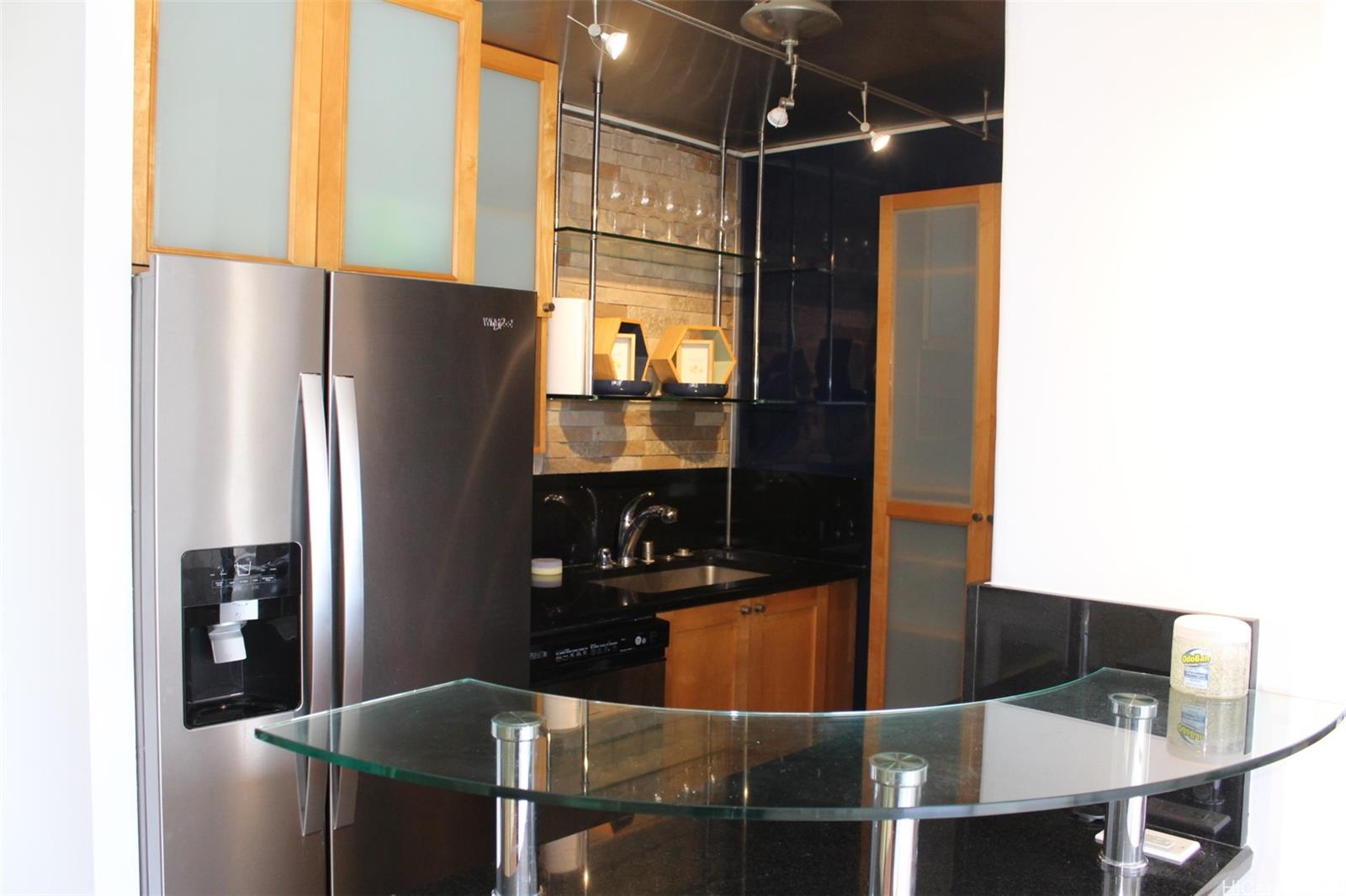 775 Kinalau Place, Unit 2107 Honolulu, HI 96813 - Photo 7 of 13 a kitchen with stainless steel appliances kitchen island a refrigerator a stove and a sink