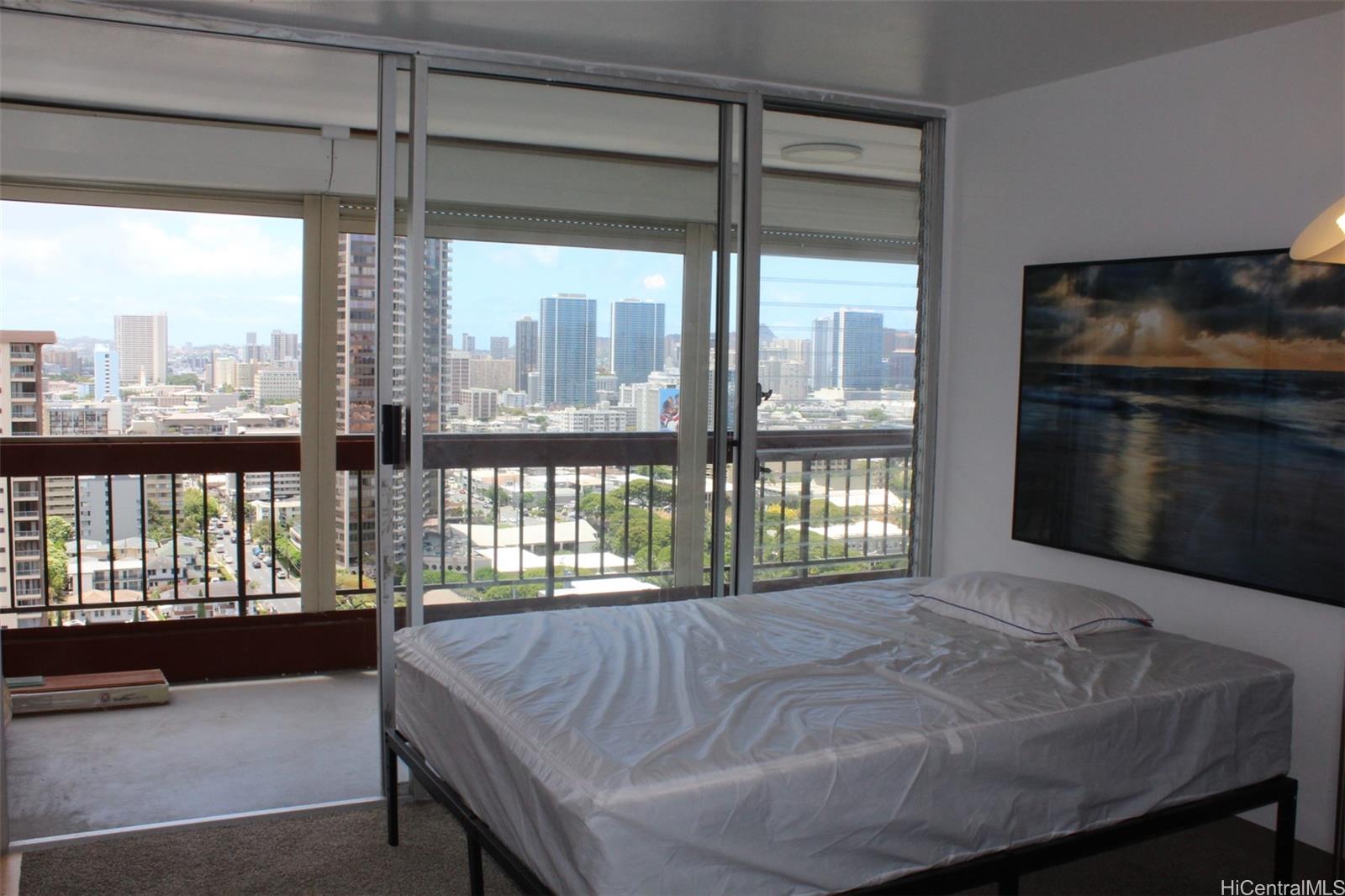 775 Kinalau Place, Unit 2107 Honolulu, HI 96813 - Photo 9 of 13 a bed sitting in a balcony next to a window