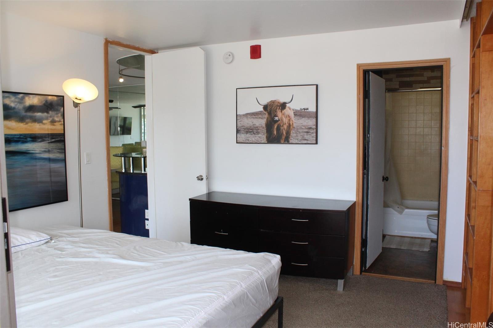 775 Kinalau Place, Unit 2107 Honolulu, HI 96813 - Photo 10 of 13 a bedroom with a bed and a closet