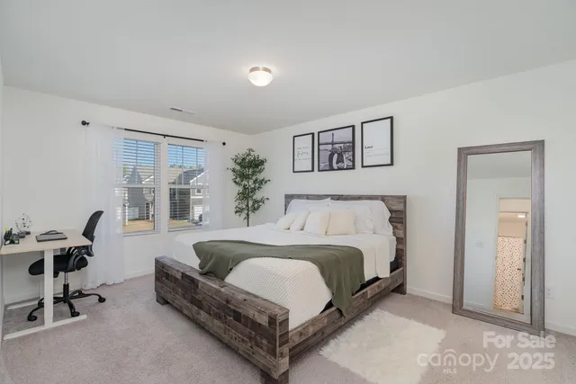 a spacious bedroom with a bed and a desk