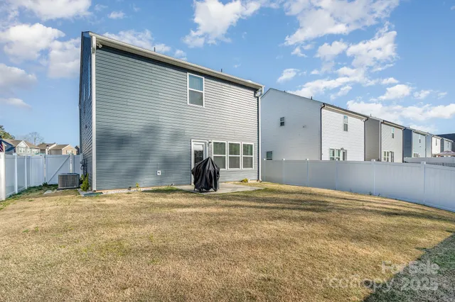 a view of a house with wooden fence
