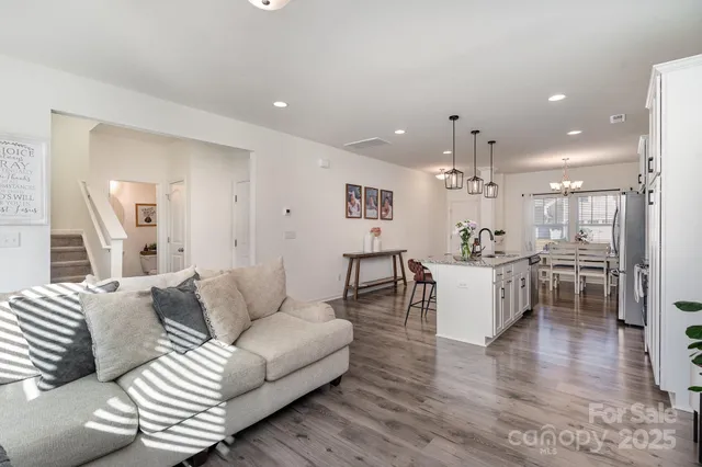 a living room with furniture and kitchen view